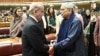 This handout photograph taken and released on March 3, 2024 by the Pakistan National Assembly, shows Pakistan's former President Asif Ali Zardari (R) greeting newly-elected Pakistan's Prime Minister Shehbaz Sharif (L) at the Parliament House in Islamabad.