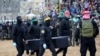 Palestinian militants carry one of the coffins as they hand over the bodies of four Israeli hostages to the Red Cross in Khan Yunis in the southern Gaza on February 20, 2025.