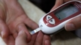 A patient takes a blood glucose test during an event aimed to help people with diabetes to cope with their illness at Saint Luka diagnostics medical center in Sofia, November 13, 2012. Picture taken November 13, 2012. REUTERS/Stoyan Nenov (BULGARIA - 