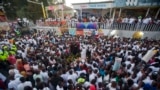 Families and friends gather around a memorial at the site of a high-voltage wire accident that left at least 16 people dead, during a vigil in Port-au-Prince, Haiti, Feb. 17, 2015. 